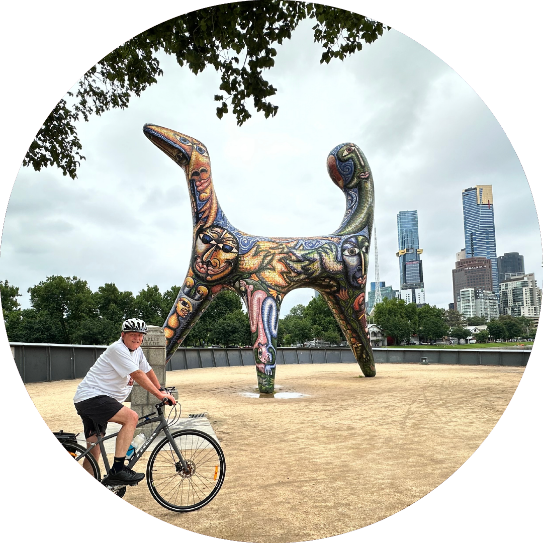 Stuart cycling in Melbourne. Sculpture is Angel by Deborah Halpern