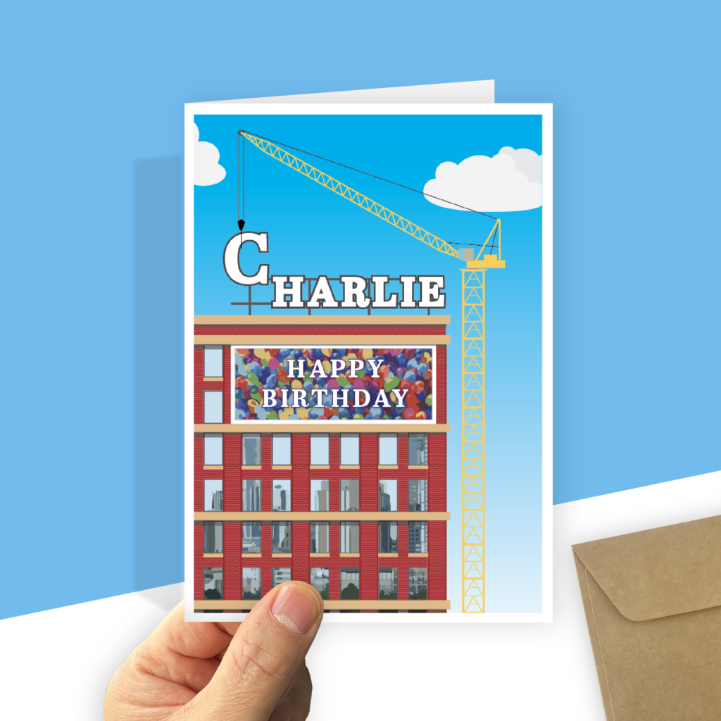 The card is an illustration of a building with a crane erecting your recipient's name as a rooftop sign.